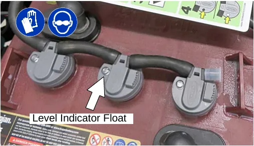 Photo of the level indicator float on a battery cap with an arrow pointing to it