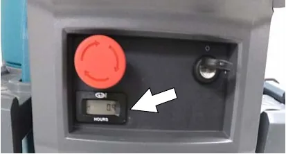 Photo of the hour meter on the control console with an arrow pointing to it