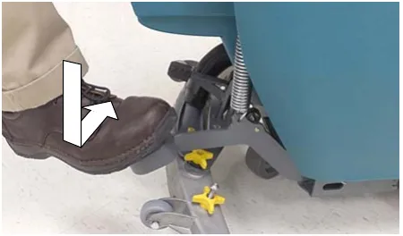 Photo of a foot stepping down on the scrub head lift pedal