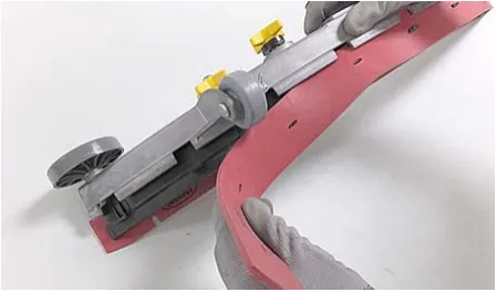 Photo of the worn blade being removed from the blade retainer