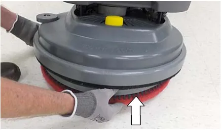 Photo of the Insta-Click pad driver being lifted up into the scrub head until it clicks