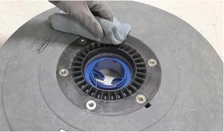 Photo of cleaning debris from the hub connection area of an Insta-Click pad driver