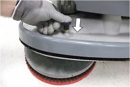 Pushing the pad release plunger downward to release the pad driver