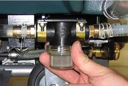 Solution tank filter under the machine held in a hand