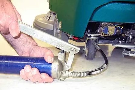 Greasing a caster with a grease gun