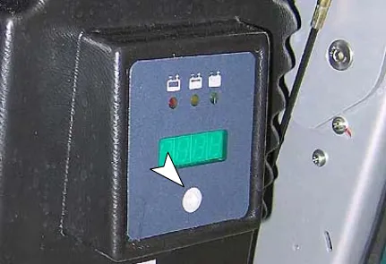 Charger display and arrow button, marked by an arrow