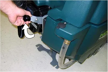 Hand lifting the squeegee lift lever upward