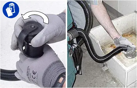 Removing the recovery tank drain hose cap and draining the tank into a sink