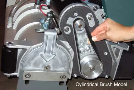 Checking belt tension on a brush motor by twisting the belt at its midpoint, cylindrical brush model