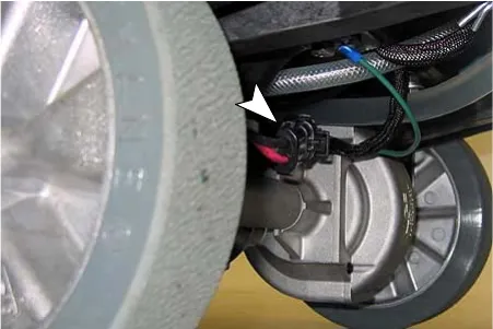 Drive motor wire connector, marked by an arrow