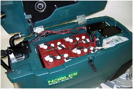 Four batteries installed in the battery compartment tray of the machine