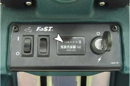 Hour meter on the control panel marked by an arrow