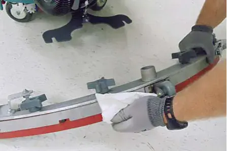 Wiping the squeegee blades clean with a cloth