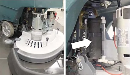 Cartridge location behind the right side brush motor, marked by an arrow