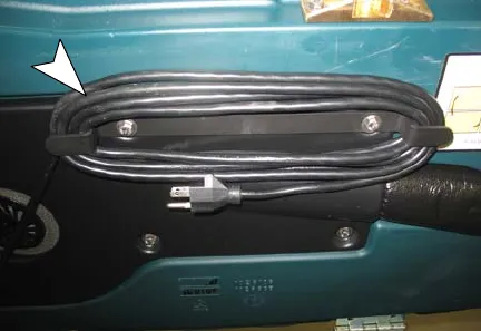 AC power cord wrapped on its storage hooks under the recovery tank
