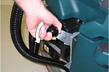 Lowering the squeegee lift lever to start the vacuum motor
