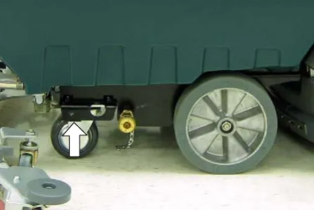 Arrow pointing to the designated jacking location near the rear caster and wheel
