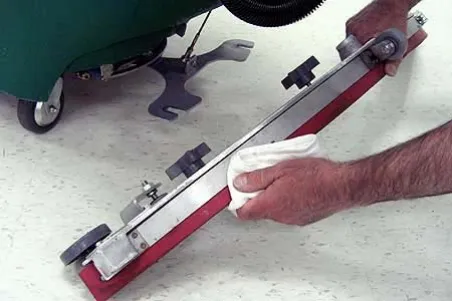 Wiping the squeegee blades clean with a cloth
