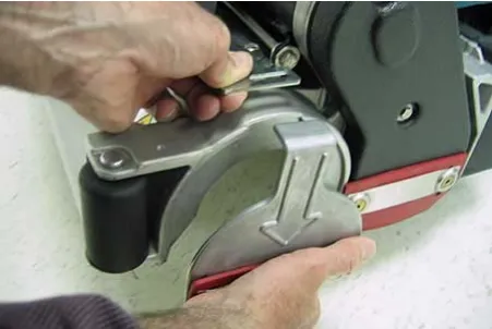 Idler plate being removed from the brush