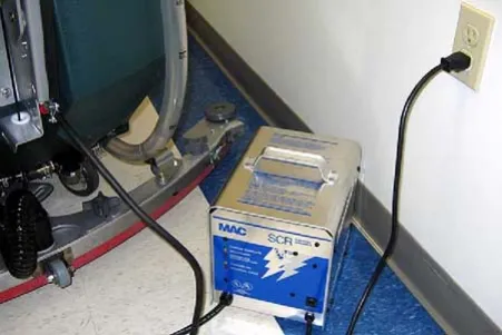 Off-board charger connected to the machine and plugged into a wall receptacle