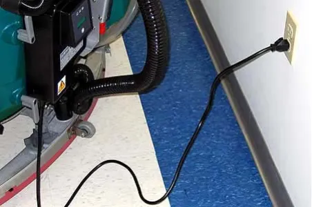 Charger AC power cord plugged into a wall receptacle