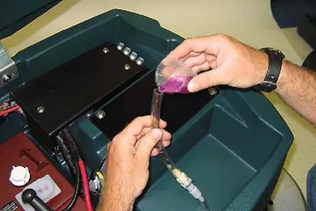 Pouring RV anti-freeze into the supply hose until full