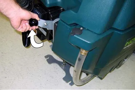 Hand lifting the squeegee lift lever to the upward position