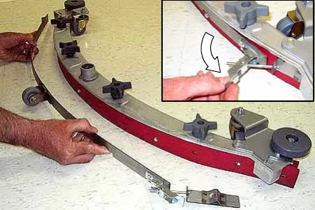 Loosening the band clamp and removing the band from the squeegee assembly