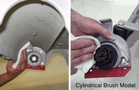 Wiping debris from the underside of the cylindrical brush scrub head, idler plates and drive hubs