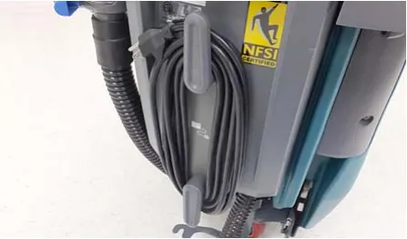 Charger power cord wrapped around the cord hooks on the machine