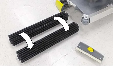 Two cylindrical brushes with arrows showing them being swapped front to rear