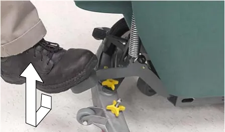 Foot stepping down on the scrub head lift pedal, arrows showing the motion