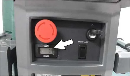 Hour meter on the control console, arrow pointing at it