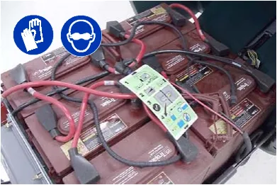 Battery watering system hoses and connections on top of the batteries