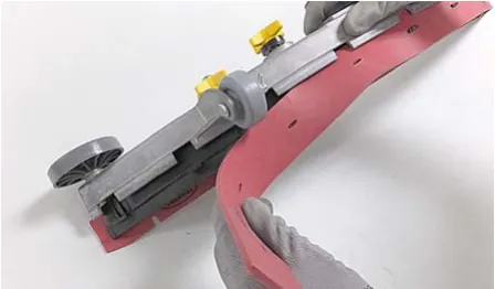 Worn squeegee blade being pulled out of the blade retainer