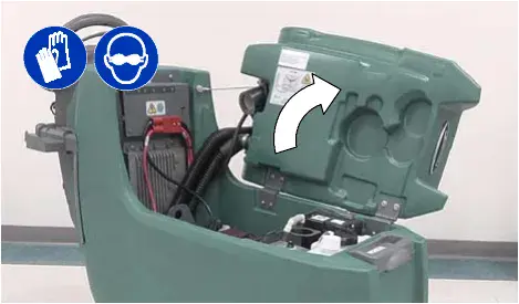 Recovery tank lifted to reach the battery compartment, with an arrow showing the lift direction