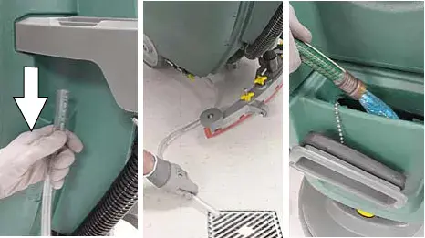 Solution hose pulled down, draining over a floor drain, and the solution tank being rinsed