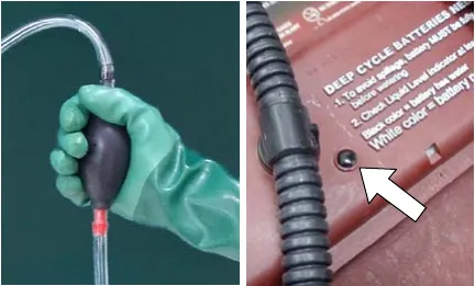 Hand squeezing the bulb on the hand pump hose, and a level indicator on the battery cover