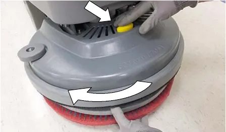 Pressing the plunger on a single disk head while turning the pad driver clockwise to remove it