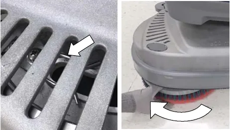 Spring clip lug slot seen through the scrub head window, and the pad driver being turned toward the spring clip
