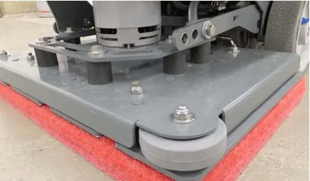Orbital scrub head showing the deck plate, driver plate and isolators