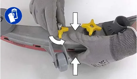Hands loosening the two outside knobs on the squeegee assembly while squeezing the blade retainer and frame together