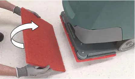 Orbital work pad being turned over, arrow showing the flip