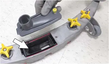Drip trap cover removed from the squeegee assembly with an arrow pointing to the reservoir