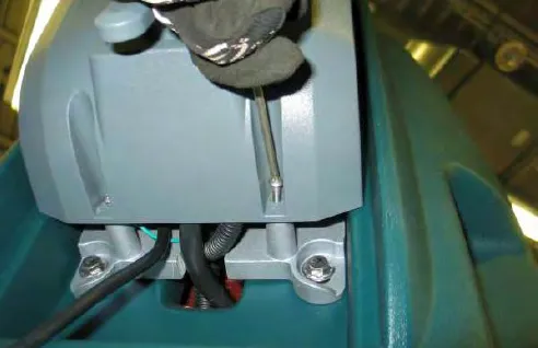 Removing a torx screw from under the control console