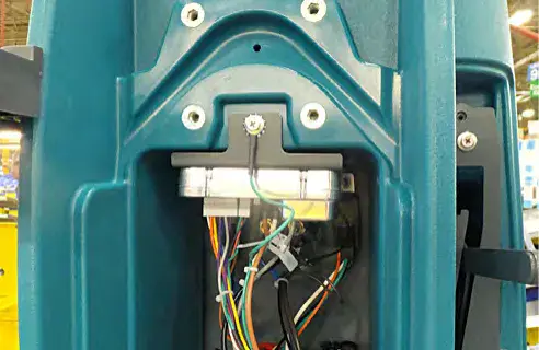 I-Drive module in the console cavity with its wiring and two mounting screws