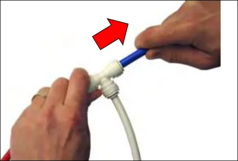 Pulling on the tube to check that the connection is secure, with a red arrow