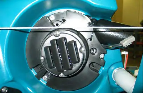 Vacuum fan housing seen from inside the recovery tank area with its wire harness connector