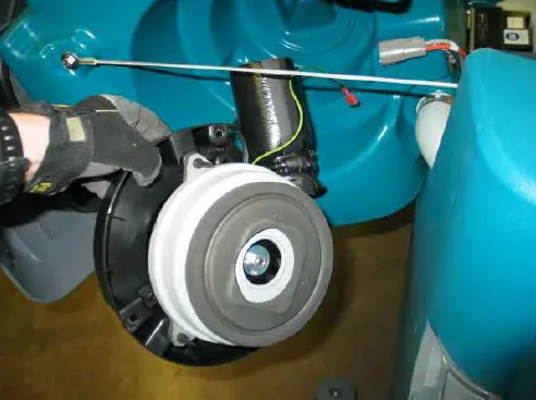 Vacuum fan assembly being lifted out of the machine