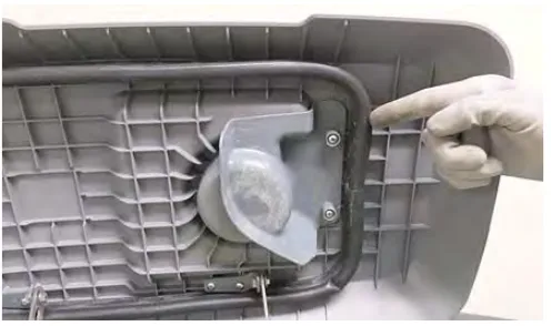 Recovery tank lid underside with a finger pointing to the lid seal